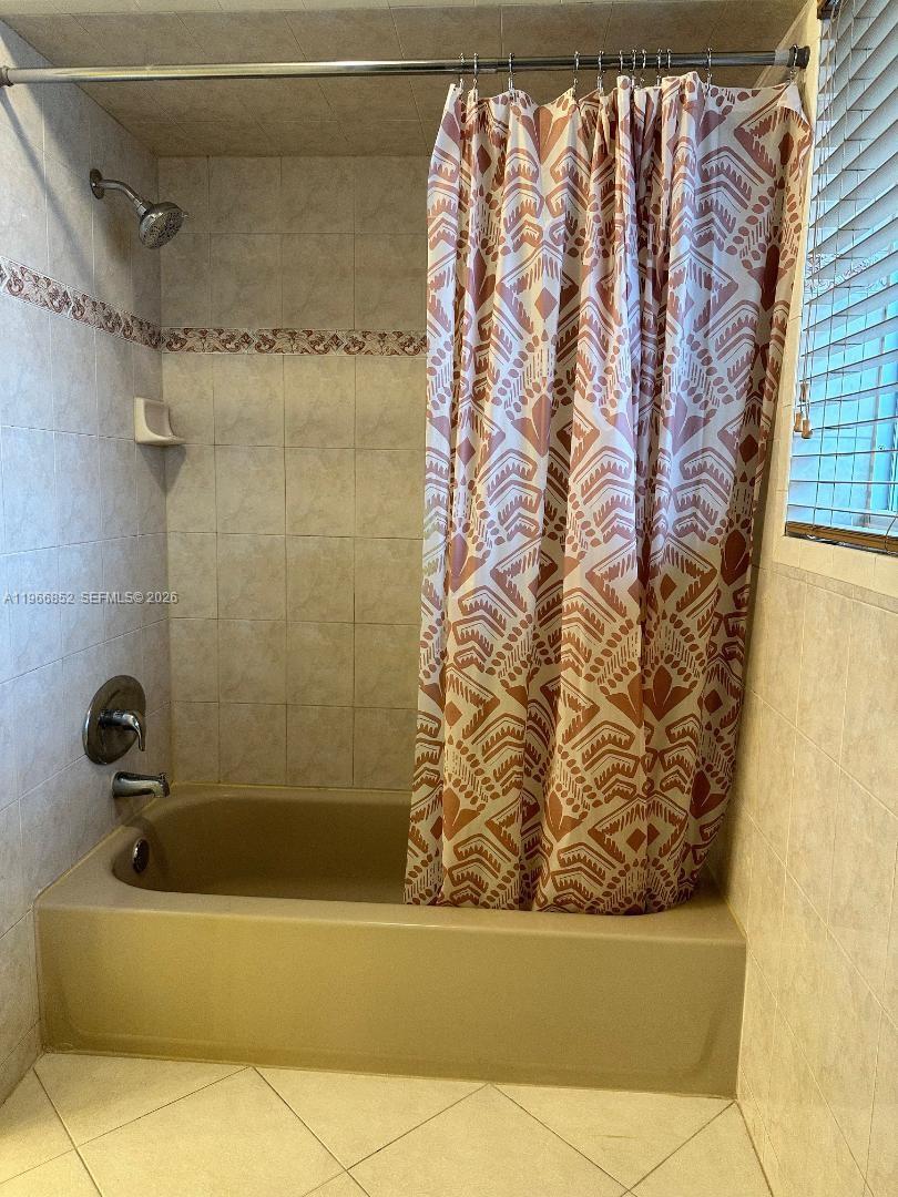 7205 West 3rd Avenue Hialeah, FL 33014 - Photo 19 of 28 a bathroom with a bathtub and shower