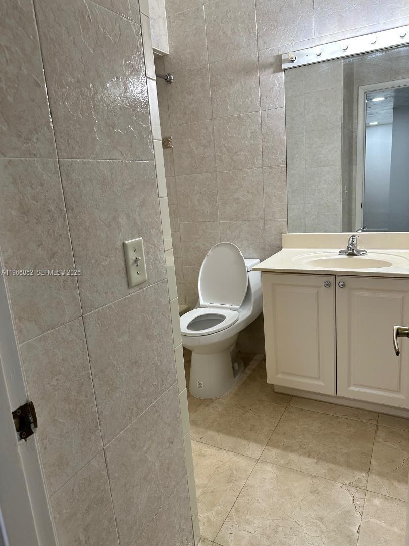 7205 West 3rd Avenue Hialeah, FL 33014 - Photo 22 of 28 a bathroom with a sink a toilet and shower