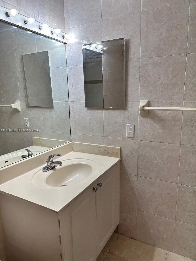 7205 West 3rd Avenue Hialeah, FL 33014 - Photo 24 of 28 a bathroom with a sink and a mirror