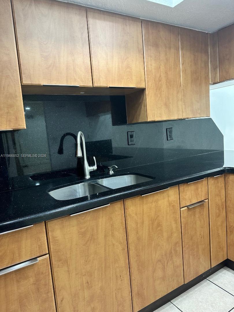 7205 West 3rd Avenue Hialeah, FL 33014 - Photo 3 of 28 a kitchen with a sink and a cabinets