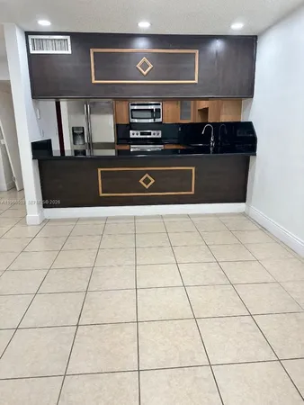 a kitchen with stainless steel appliances granite countertop a stove a sink and a counter top