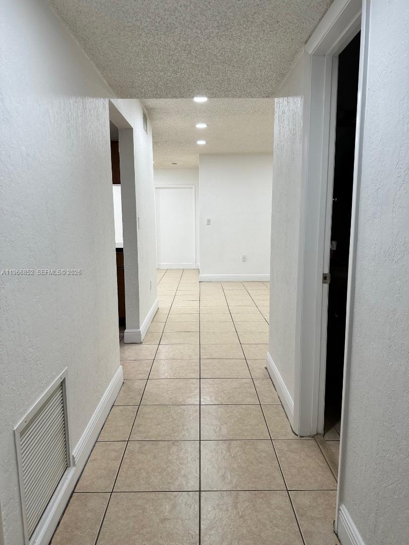 7205 West 3rd Avenue Hialeah, FL 33014 - Photo 8 of 28 a view of hallway with a window and a refrigerator