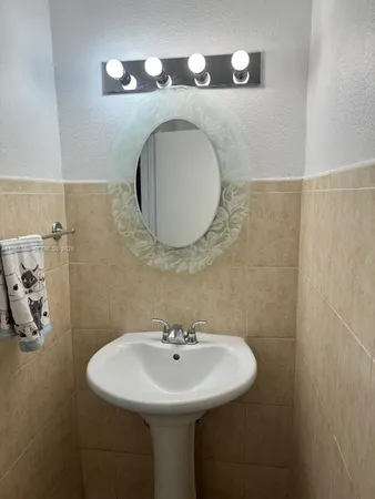 a bathroom with a sink and mirror