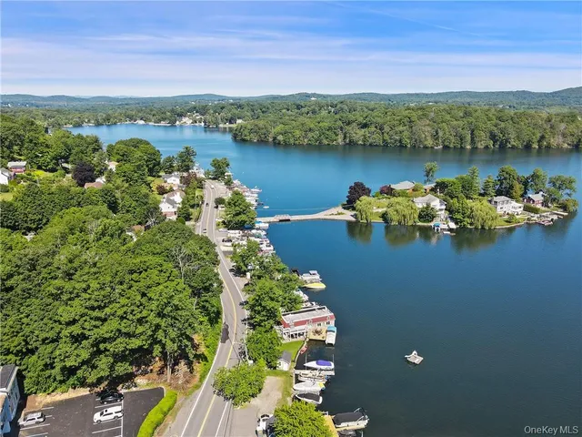 an aerial view of a houses with a lake view