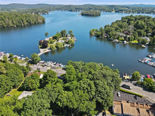 an aerial view of a houses with a lake view