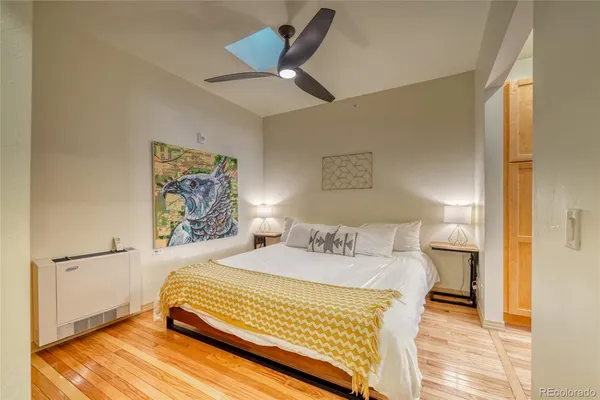 a room with a bed and glass door