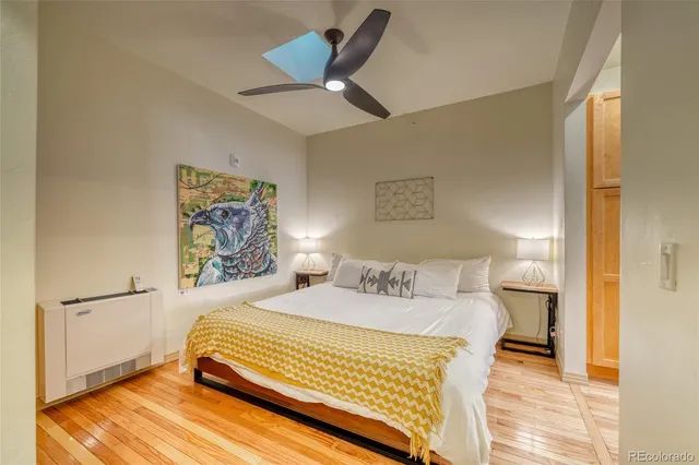 a room with a bed and glass door