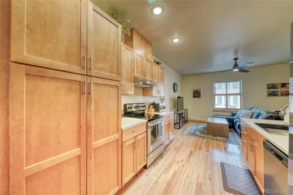 a kitchen with a stove a sink and a refrigerator