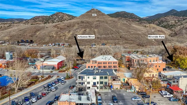 a view of a brick house with a red door and a large window
