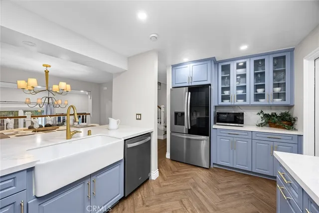 a kitchen with a sink stainless steel appliances and cabinets