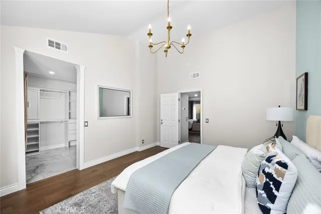 a bedroom with a bed and a chandelier