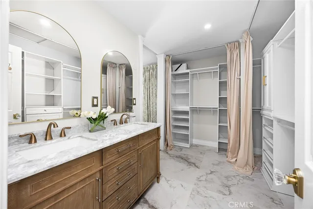 a bathroom with a double vanity sink and a mirror