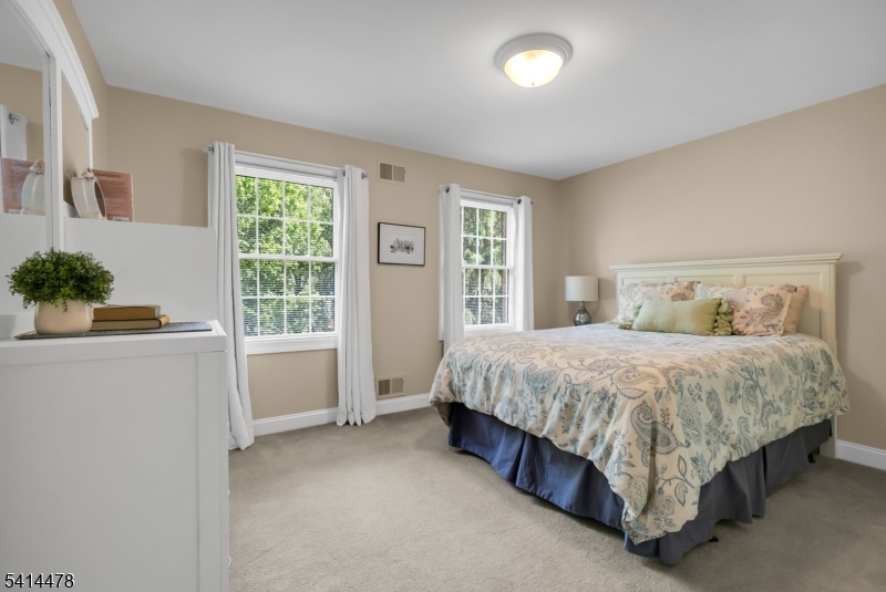 33 St Nickolas Way Bernards, NJ 07920 - Photo 26 of 50 a spacious bedroom with a bed and a window