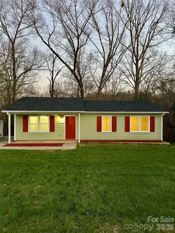 a front view of house with yard and trees