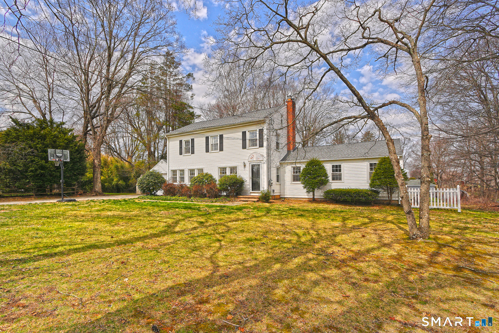 167 Porter Lane Orange, CT 06477 - Photo 1 of 1 a house that has a tree in front of it