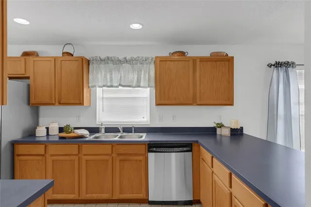 a kitchen with stainless steel appliances granite countertop a sink and cabinets
