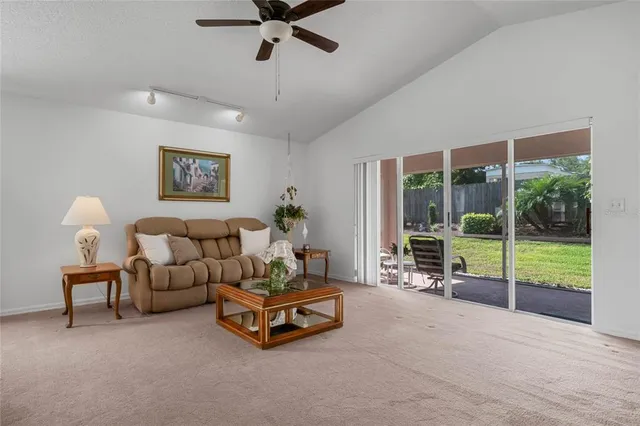 a living room with furniture and a floor to ceiling window