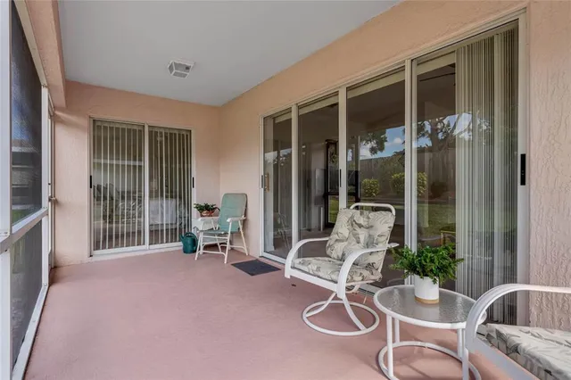 a living room with furniture windows and a potted plant
