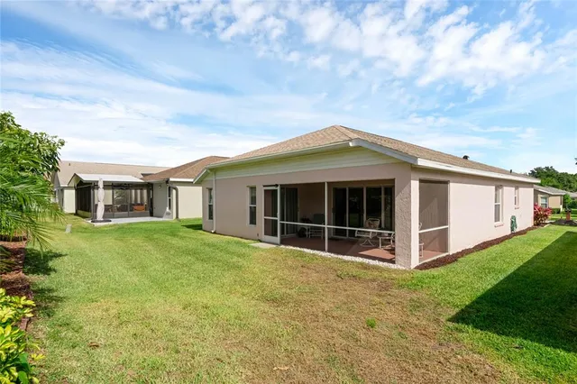 a view of a house with a yard and sitting area