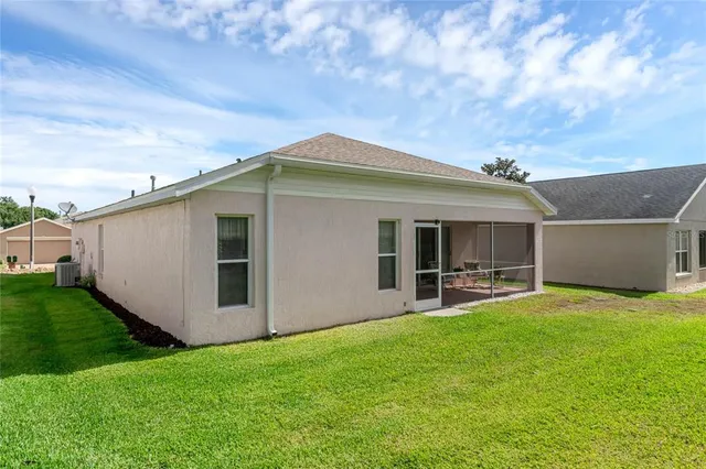 a backyard of a house with table and chairs