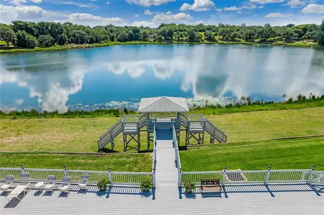 an aerial view of a house with a lake view