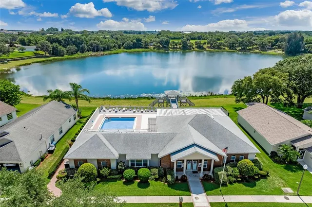 an aerial view of a house with a lake view