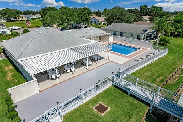 an aerial view of a house with a garden and lake view