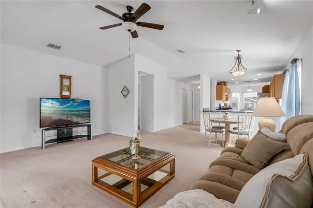 a living room with furniture a rug and a flat screen tv