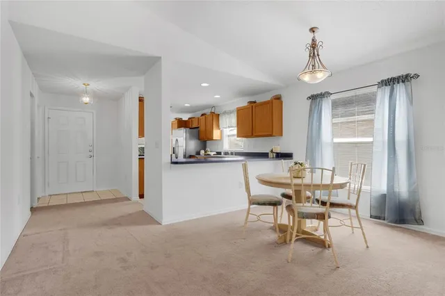 a living room with furniture a dining table and a window