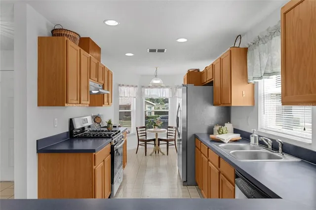 a kitchen with a sink stove and cabinets
