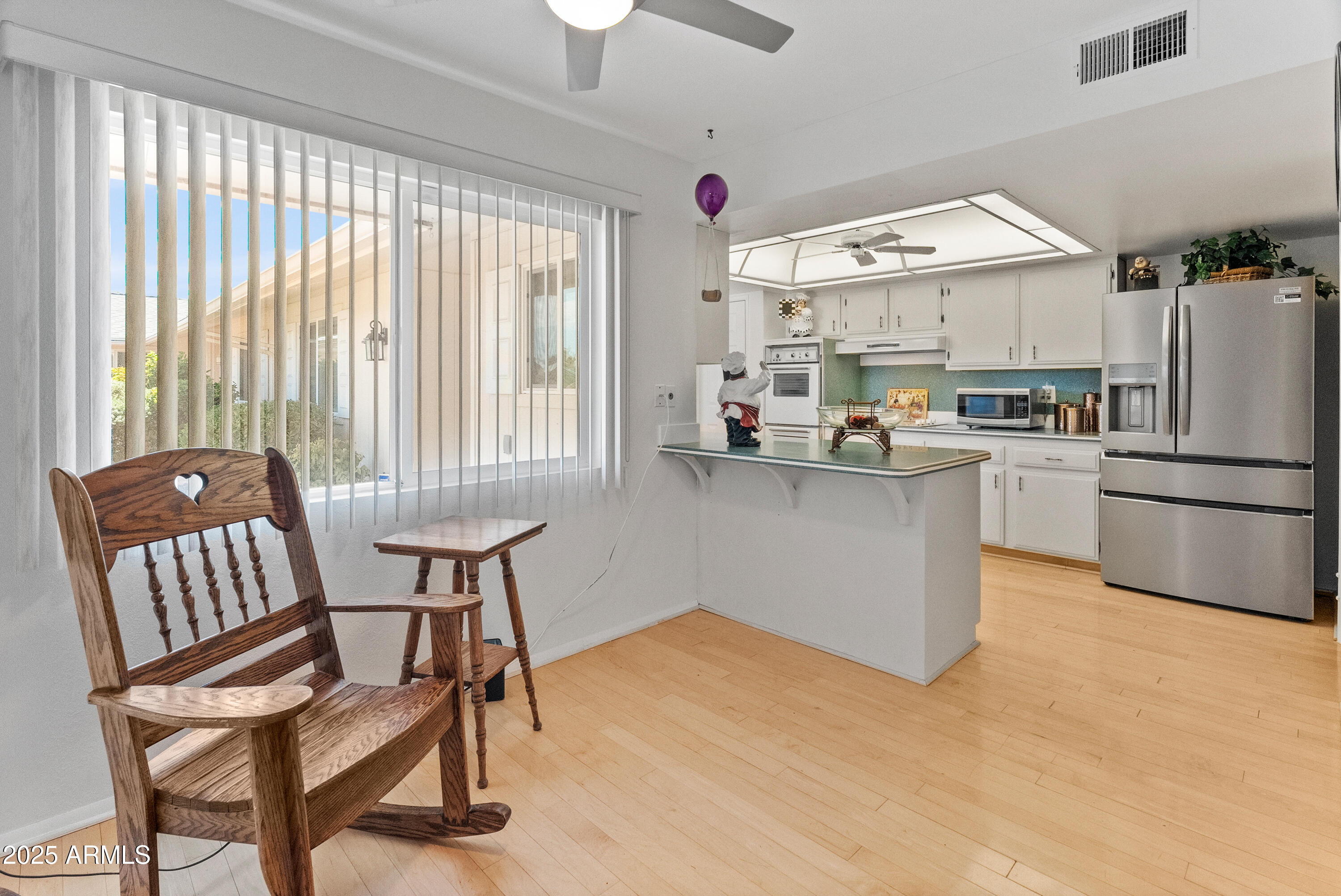 10229 West Bolivar Drive Sun City, AZ 85351 - Photo 11 of 54 a kitchen with stainless steel appliances granite countertop a stove a sink a refrigerator and a dining table
