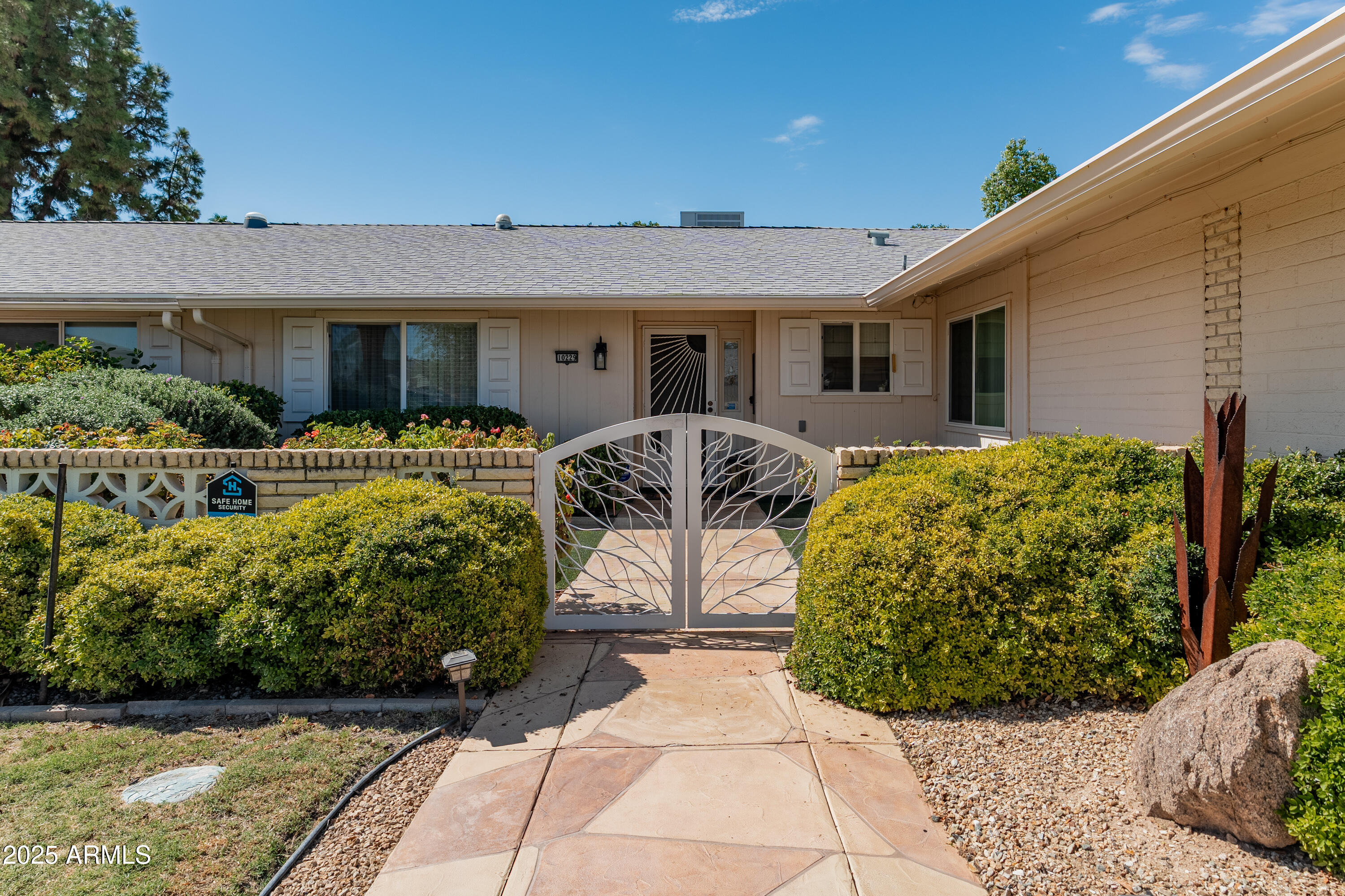 10229 West Bolivar Drive Sun City, AZ 85351 - Photo 2 of 54 a front view of a house with garden