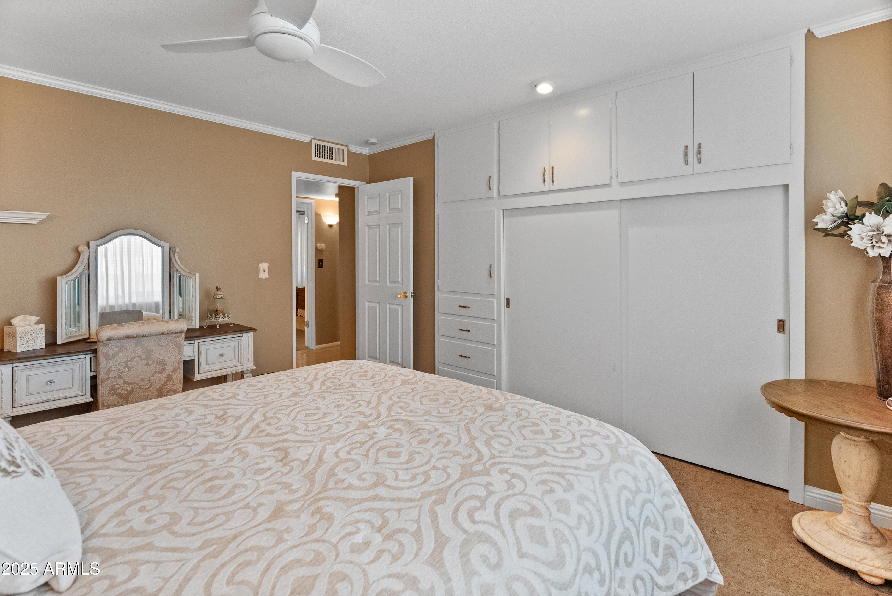 10229 West Bolivar Drive Sun City, AZ 85351 - Photo 26 of 54 a bedroom with a bed and a table in it