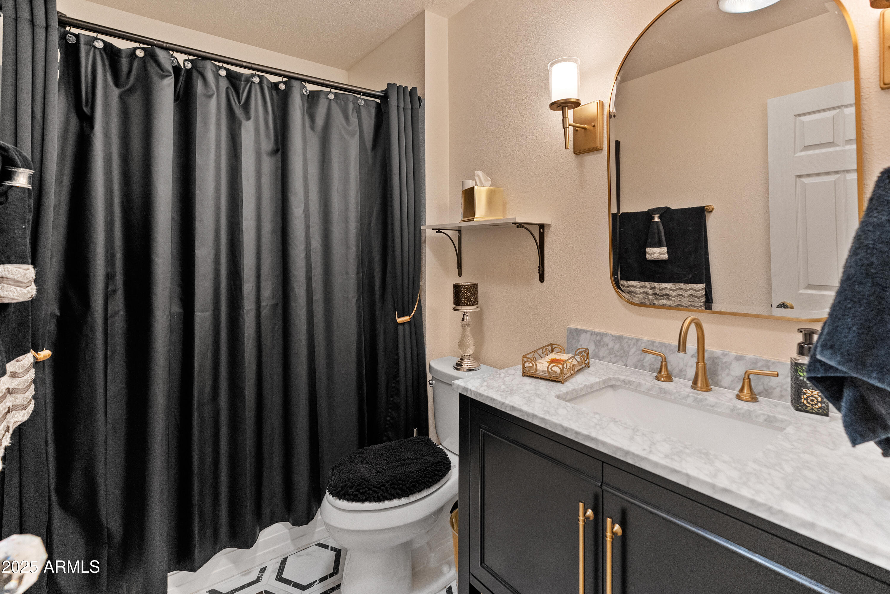 10229 West Bolivar Drive Sun City, AZ 85351 - Photo 27 of 54 a bathroom with a granite countertop sink and a mirror
