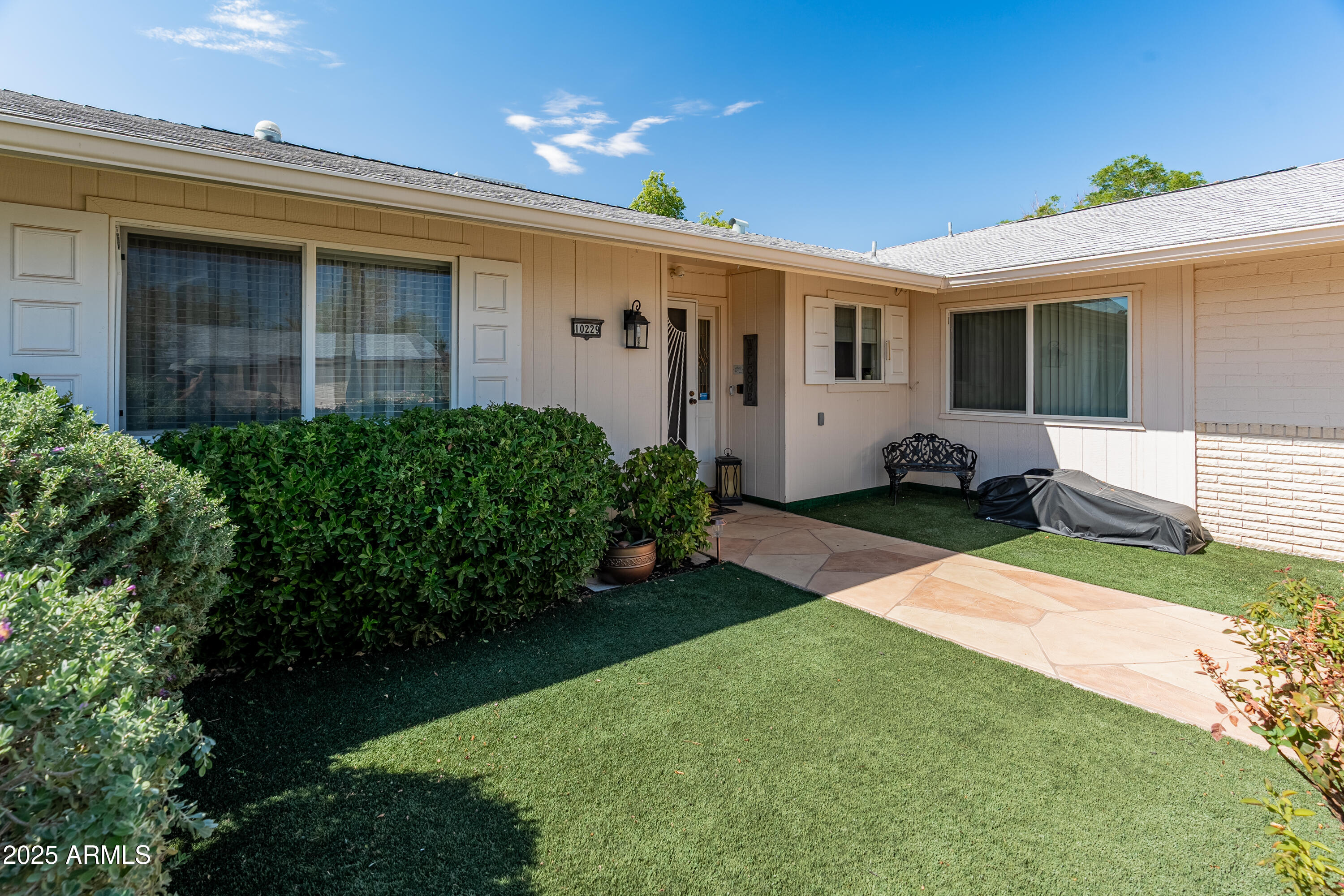 10229 West Bolivar Drive Sun City, AZ 85351 - Photo 3 of 54 a front view of a house with garden