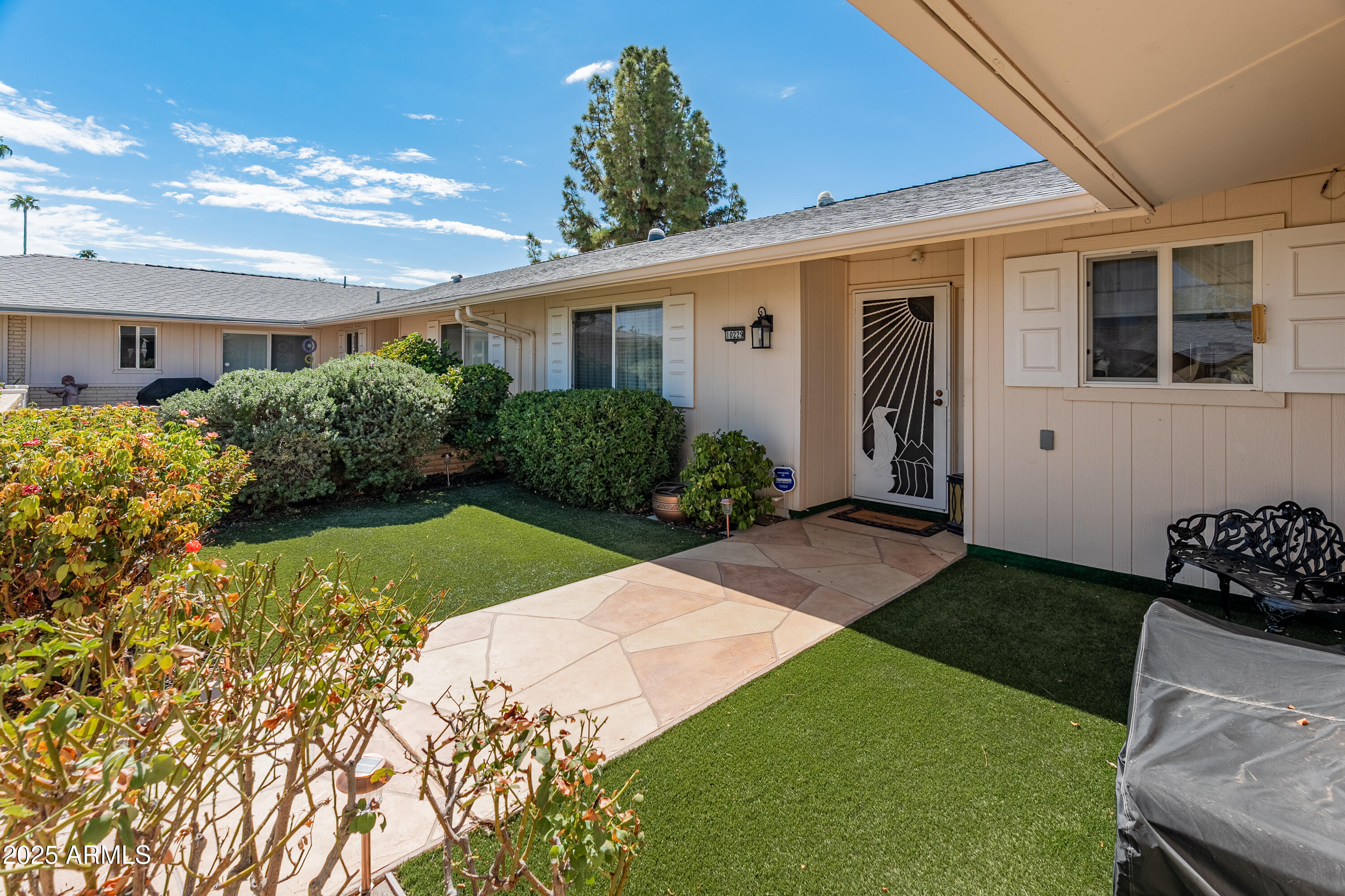 10229 West Bolivar Drive Sun City, AZ 85351 - Photo 51 of 54 a front view of a house with garden