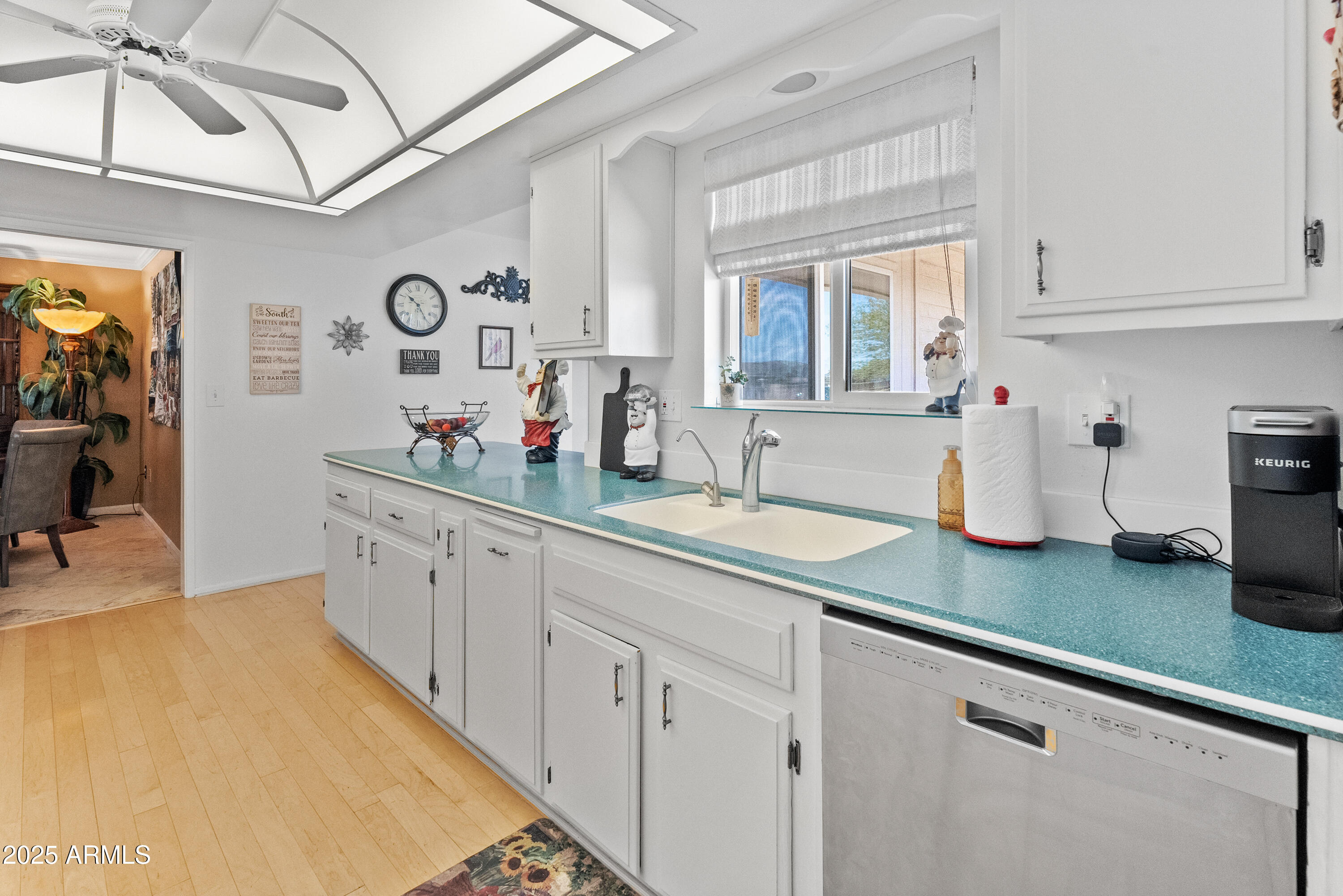 10229 West Bolivar Drive Sun City, AZ 85351 - Photo 6 of 54 a kitchen with sink and cabinets