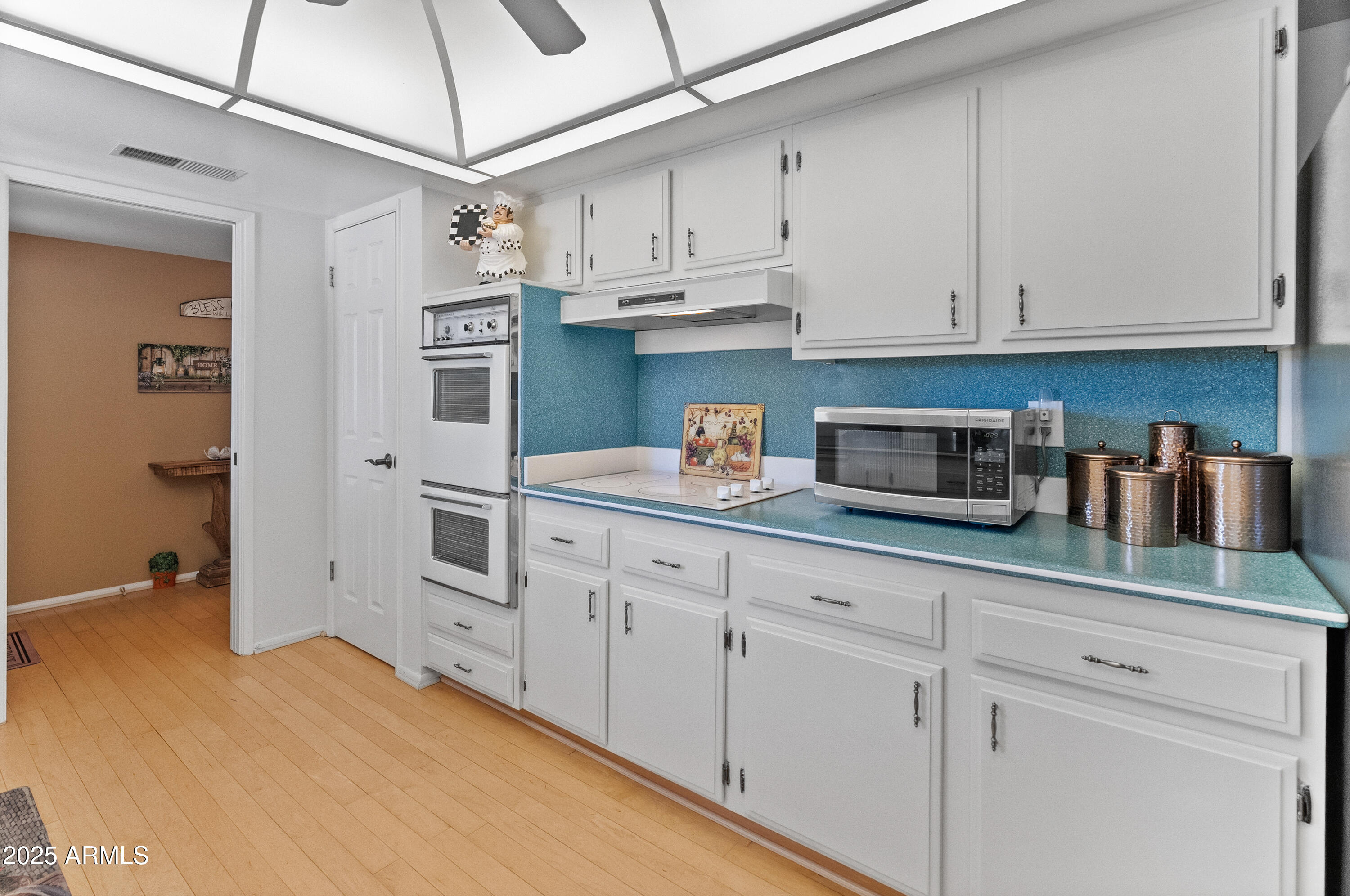10229 West Bolivar Drive Sun City, AZ 85351 - Photo 8 of 54 a kitchen with stainless steel appliances granite countertop white cabinets and a sink