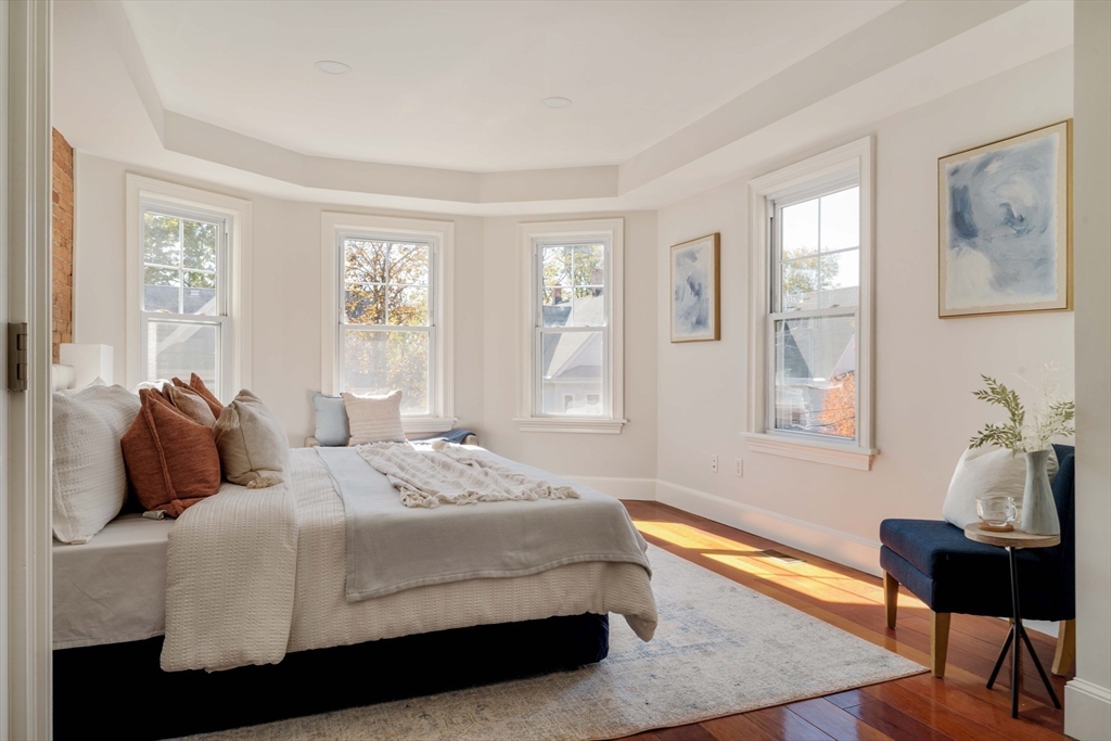 32 Hall Avenue, Unit 32 Somerville, MA 02144 - Photo 11 of 30 a bedroom with a bed and wooden floor