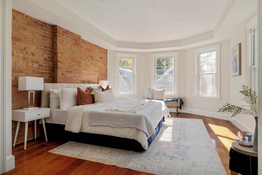 32 Hall Avenue, Unit 32 Somerville, MA 02144 - Photo 12 of 30 a spacious bedroom with a bed and wooden floor