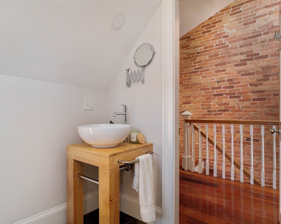 32 Hall Avenue, Unit 32 Somerville, MA 02144 - Photo 24 of 30 a bathroom with a sink and a mirror