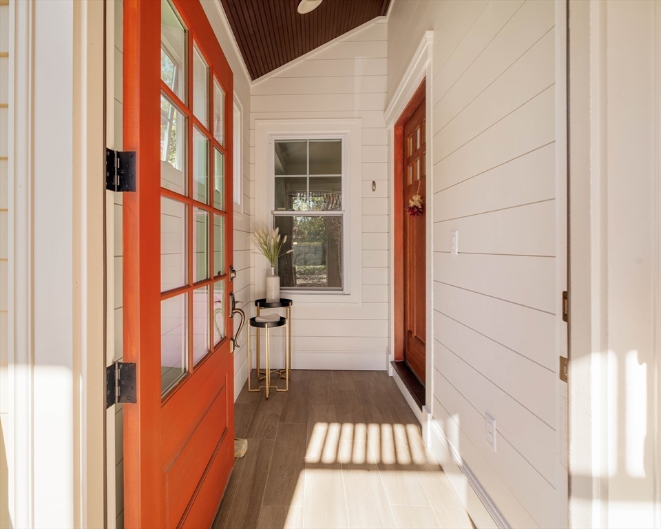 32 Hall Avenue, Unit 32 Somerville, MA 02144 - Photo 26 of 30 a view of an entryway with a floor to ceiling window and wooden floor