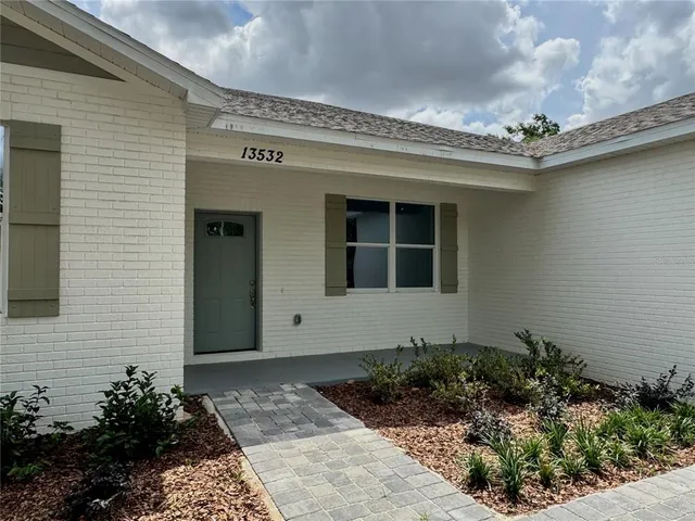 a kitchen with stainless steel appliances a refrigerator sink and microwave