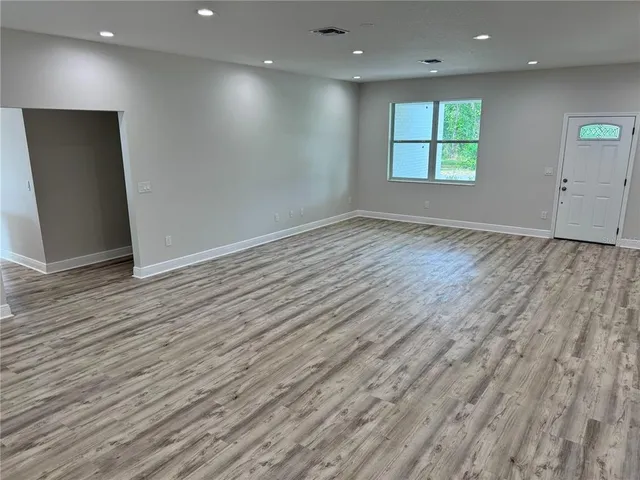 a kitchen with a refrigerator sink and cabinets
