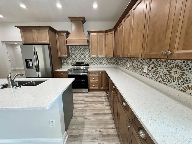 a kitchen with a sink stove and refrigerator