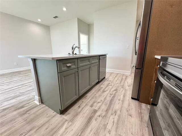 a bathroom with a sink a toilet a mirror and shower