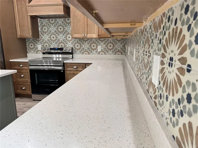 a kitchen with a stove a sink and a refrigerator