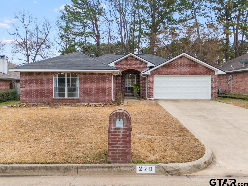 270 Frederick Circle Flint, TX 75762 - Photo 1 of 34 a front view of a house with a yard and garage