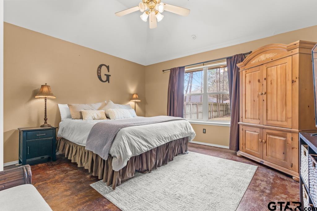 270 Frederick Circle Flint, TX 75762 - Photo 15 of 34 a spacious bedroom with a bed and a chandelier