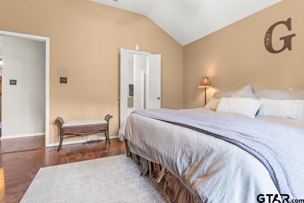 270 Frederick Circle Flint, TX 75762 - Photo 16 of 34 a bedroom with a bed and a chair with the wooden floor